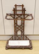 A French faux bamboo brown enamelled iron stick stand, 71cm tall