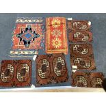 Five antique Afghan carpet fragments, a Caucasian fragment and a Turkish mat, largest 86cms x