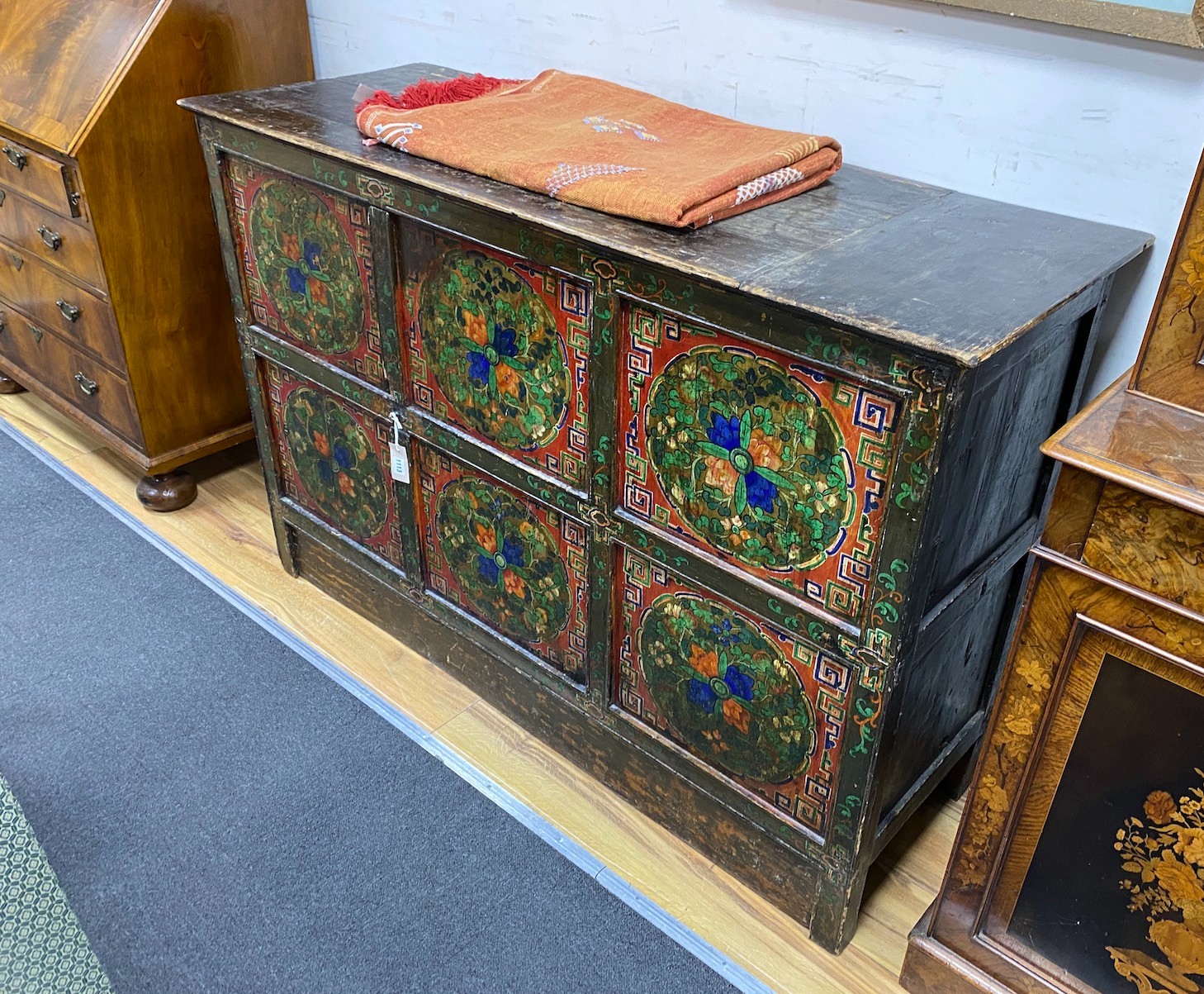 A 19th century Tibetan painted side cabinet, width 145cm, depth 52cm, height 96cm