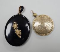 A Victorian yellow metal and seed pearl mounted black onyx oval pendant locket, with enamelled bale,
