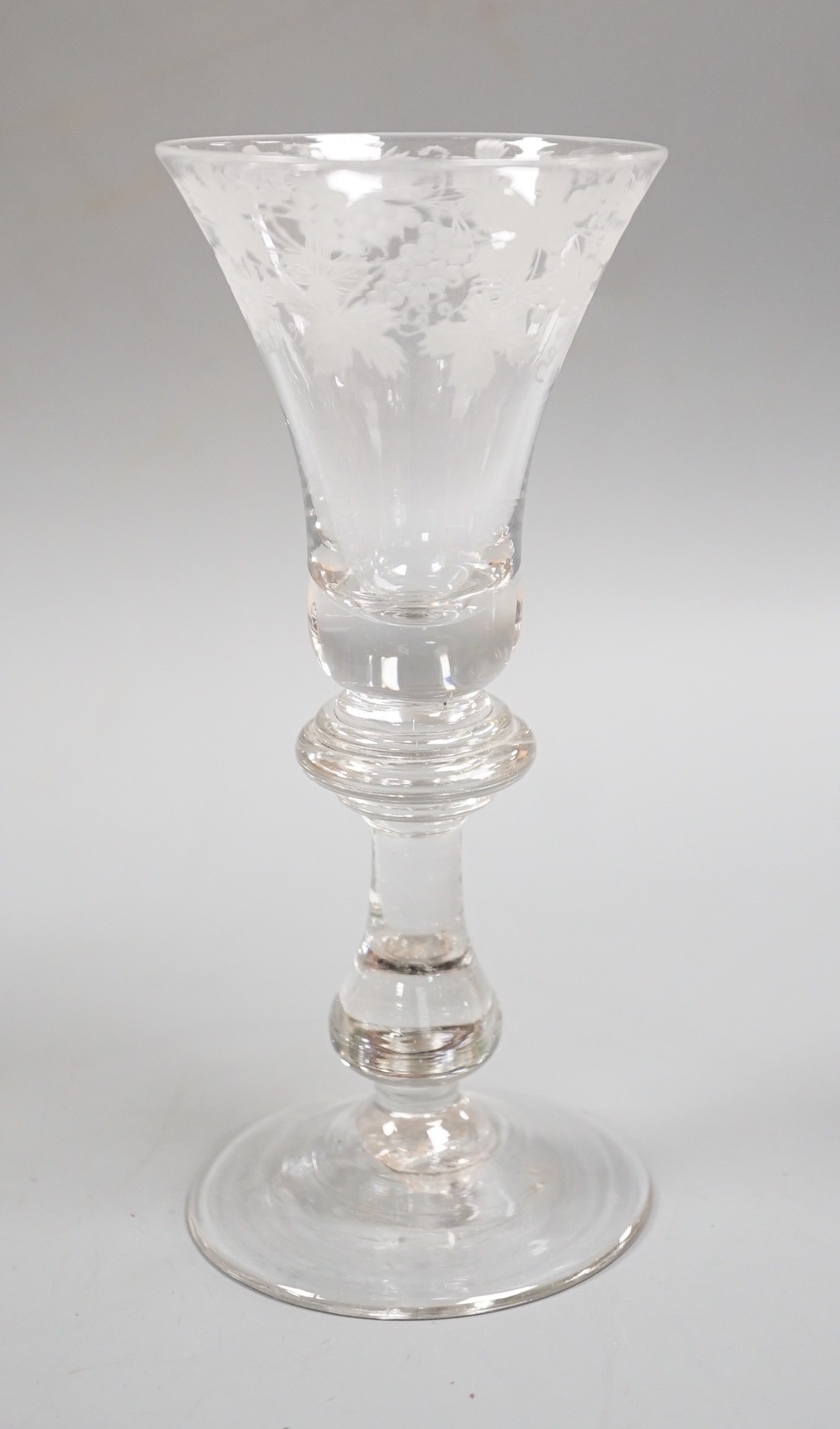 An engraved baluster stem wine glass, 17cm