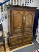 A mid 18th century panelled oak hanging cupboard on chest, fitted five small drawers, width 120cm,