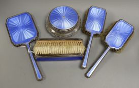 A 1930's silver and blue guilloche enamel six piece dressing table set, including hand mirror and