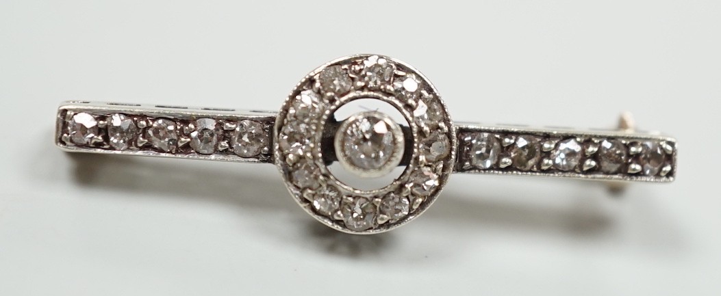 An early 20th century 9ct white metal diamond target cluster set bar brooch, 30mm, gross weight 2.