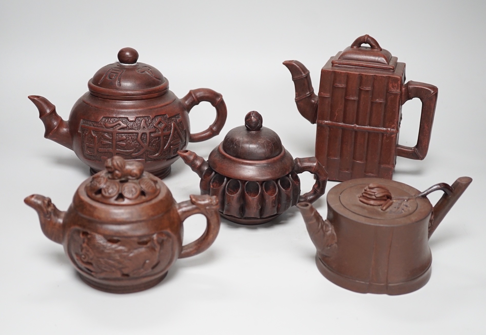 A collection of five Chinese Yixing teapots, tallest 6.5cms high
