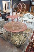 A vintage painted circular wrought iron garden table, diameter 99cm, height 70cm and six chairs, (