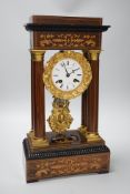 A late 19th century rosewood and marquetry portico clock with ormolu mounts