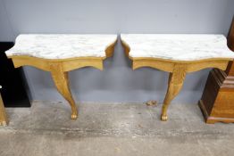 A pair of Victorian style marble topped serpentine giltwood console tables, width 84cm, depth