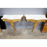 A pair of Victorian style marble topped serpentine giltwood console tables, width 84cm, depth