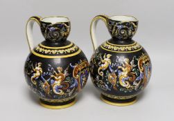 A pair of French maiolica ewers, 22cms high