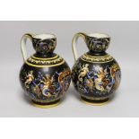 A pair of French maiolica ewers, 22cms high