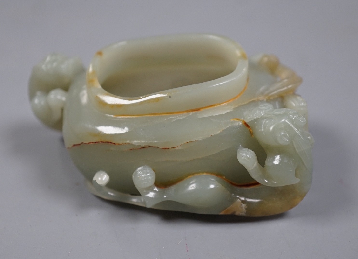 A Chinese celadon jade brushwasher, dragons