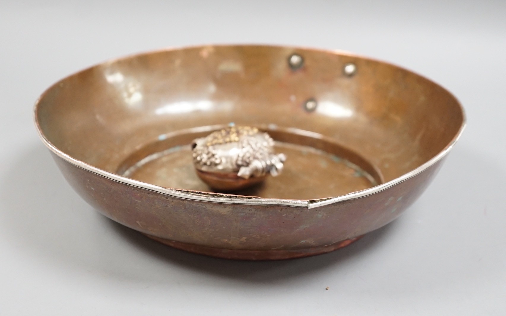 A Tibetan copper bowl and Gau, largest 28cm diameter