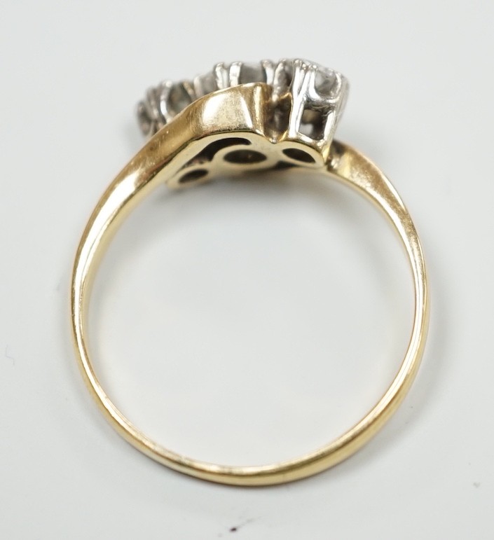 A yellow metal and three stone diamond set crossover ring, size K, gross weight 2.1 grams, the - Image 3 of 3