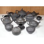 A collection of Wedgwood and other black basalt teapots and tea wares, 19th/early 20th century,