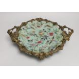 An ormolu-mounted Chinese celadon ground famille rose serving dish. 25cm wide