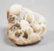 A Chinese pale grey and russet jade carving of carp amid lotus, 7.3 cm