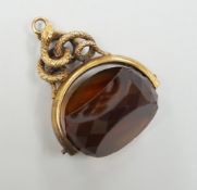 A late Victorian 15ct mounted citrine spinning fob seal, with serpent entwined bale, 34mm, gross
