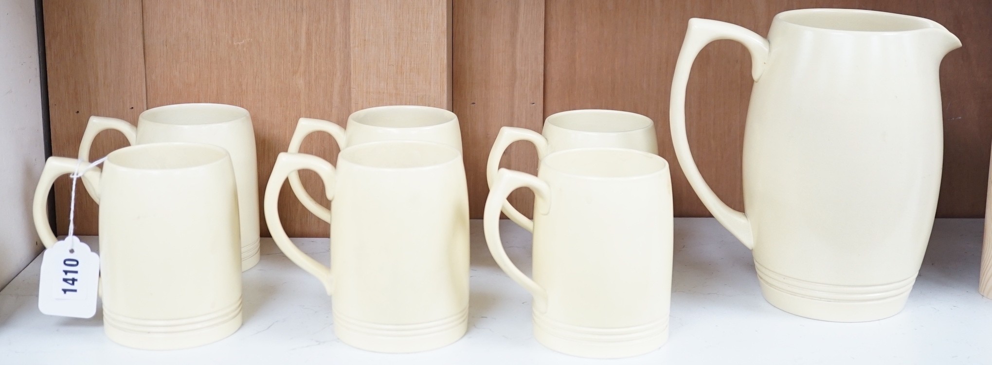 Keith Murray for Wedgwood- a cream-glazed jug and six similar mugs, jug 20.5cms high