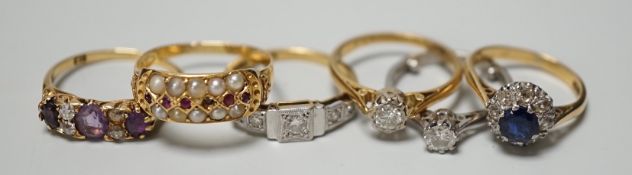 Five assorted 18ct and gem set rings, including 1920's millegrain diamond set, two solitaire diamond