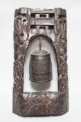 A Chinese bronze bell with wire inlaid carved hardwood stand, 44cm