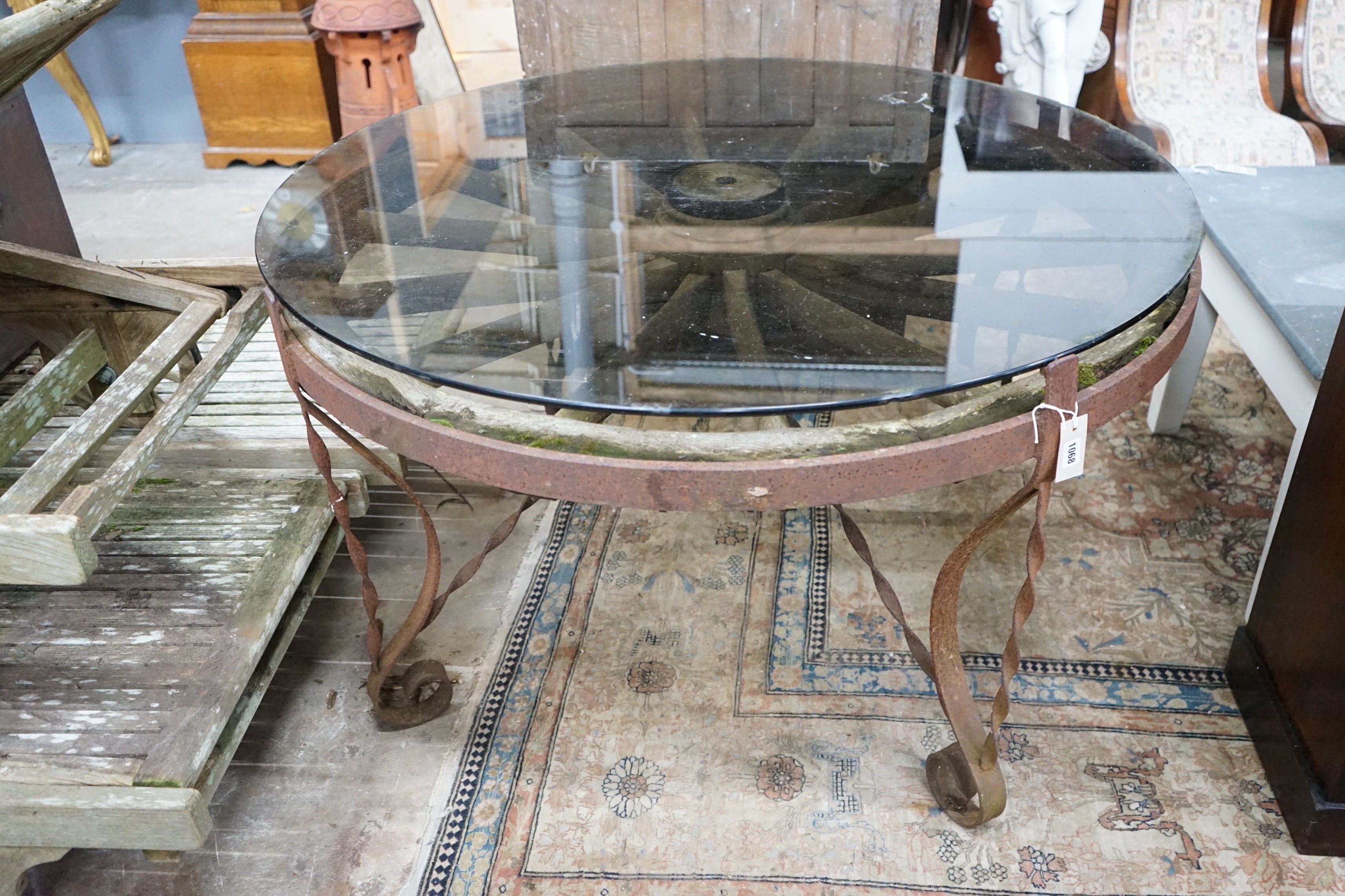 A wrought iron glass topped circular cartwheel garden table, diameter 124cm, height 72cm - Image 2 of 3