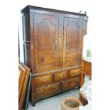 An 18th century oak hanging cupboard with later shelved interior, width 145cm, depth 56cm, height