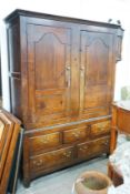 An 18th century oak hanging cupboard with later shelved interior, width 145cm, depth 56cm, height