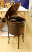 An early 20th century Tyrela parlour gramophone, in an oval mahogany table cabinet, 51 cm wide, 77