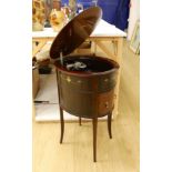 An early 20th century Tyrela parlour gramophone, in an oval mahogany table cabinet, 51 cm wide, 77