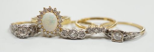 Four assorted 18ct and gem set dress rings, including white opal and diamond and two three stone