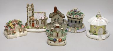 Five Staffordshire porcelain or pottery cottage or church pastille burners and a similar cottage