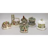 Five Staffordshire porcelain or pottery cottage or church pastille burners and a similar cottage