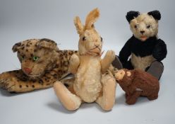 Three Steiff soft toys and a Japanese clockwork bear