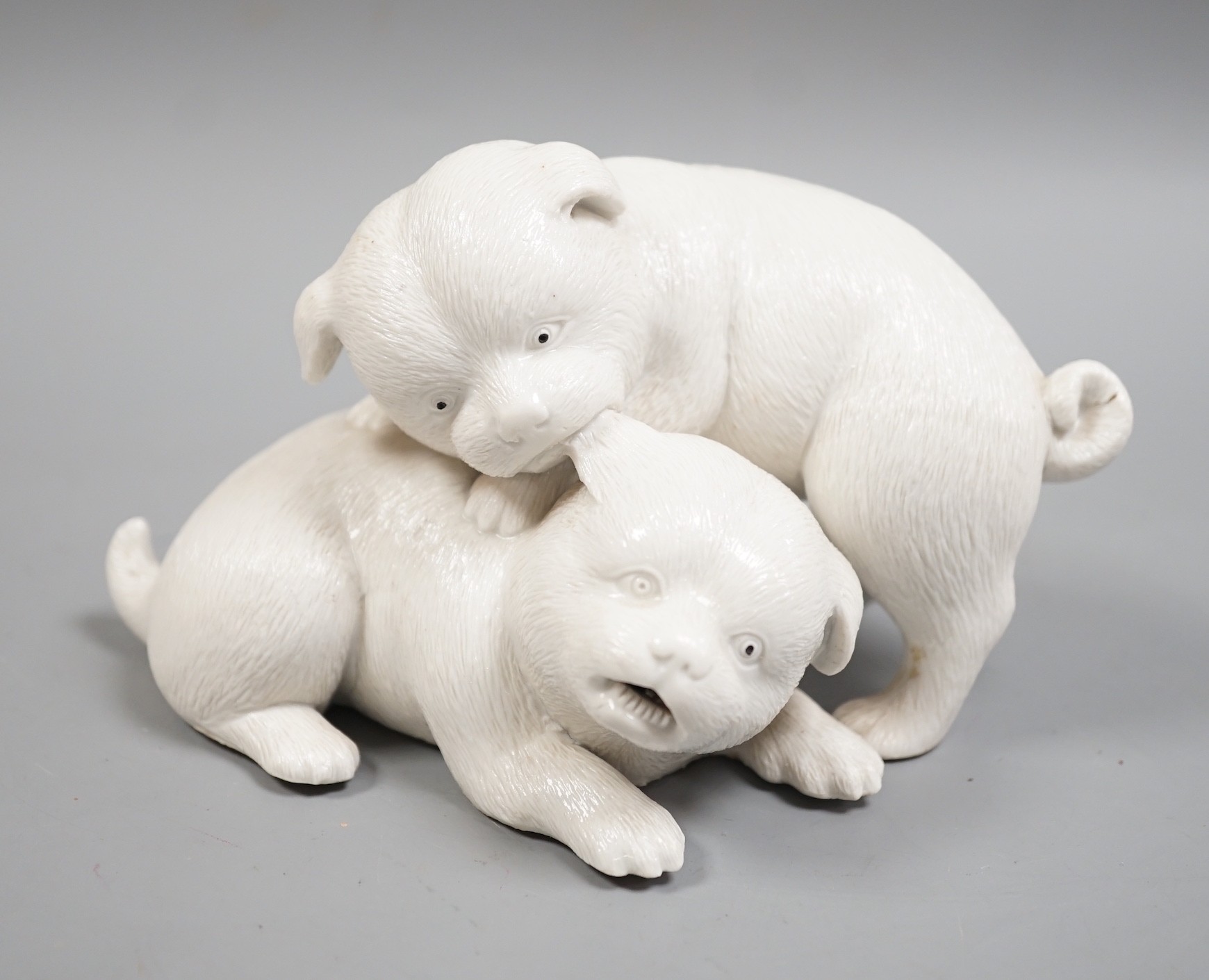 A Japanese Hirado white glazed model of two pugs, Meiji period, 17cm