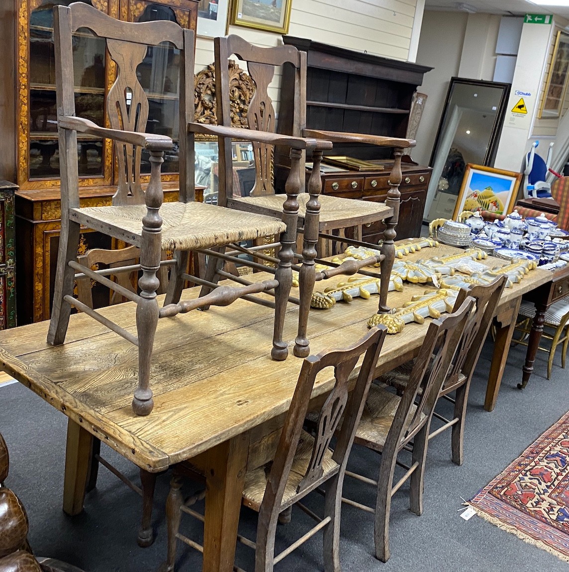 A 19th century elm plank topped kitchen dining table, on a beech underframe, the top, length