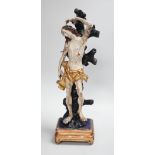 A 19th century Continental carved wooden polychrome figure of St. Sebastian on stand, total height