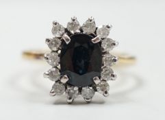 An 18k yellow metal, sapphire and diamond set rectangular cluster ring, size M, gross 4 grams.