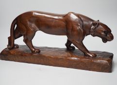 A French carved walnut model of a panther, signed Chartron, 47cms wide