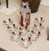 An Art Deco Bohemian ruby flashed decanter and 8 glasses, decanter 22cms high