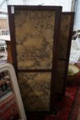 An early 20th century mahogany three fold dressing screen inset tapestry panels, each panel width