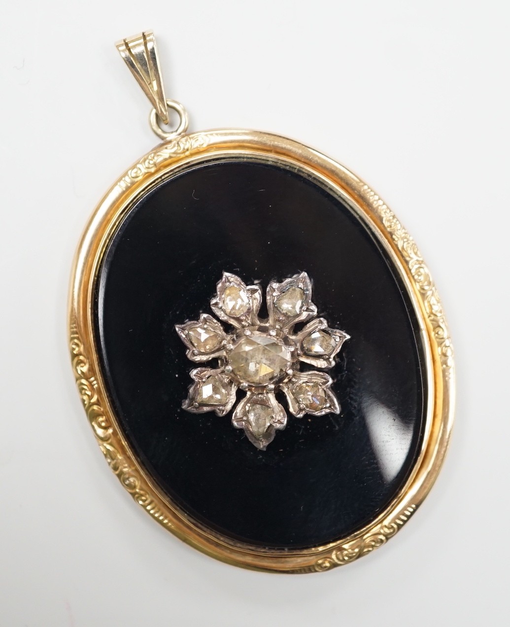 A Victorian yellow metal mounted, rose cut diamond set black onyx oval pendant, overall 56mm,