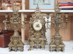 A French Gothic revival bronze clock garniture, c.1900, 56cms high