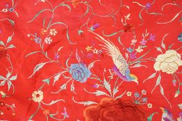 An early 20th century Chinese red silk fringed shawl, with multicoloured polychrome embroidery,