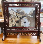 A Chinese hardwood and silk embroidered table screen, with revolving panel 38.5cms wide x 29cms