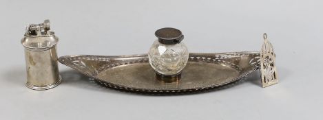 A late Victorian pierced silver mounted navette shaped inkstand, with silver mounted single glass