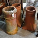 Three terracotta chimney pots, largest height 62cm