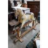 A vintage Tri-Ang rocking horse on pine safety frame, length 132cm, height 112cm