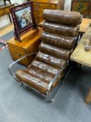 A contemporary polished stainless steel chair, with a brown leather seat and back cushion, width