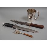 Two Bowie knives and a mug and a fork